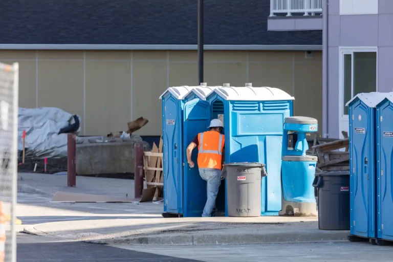 worker using toilet on building site